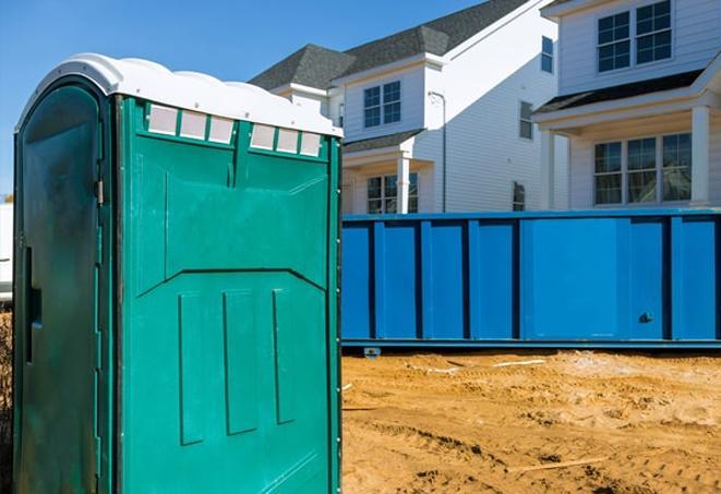 workers at a work site take advantage of convenient porta potties